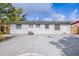 The backyard features a large concrete patio, a white cinder block exterior, and a fenced yard at 1417 Pine Lake Rd, Orlando, FL 32808