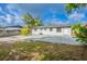 The backyard offers a concrete patio, a white cinder block exterior and a fenced perimeter at 1417 Pine Lake Rd, Orlando, FL 32808
