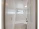 Bathroom featuring white bathtub, shower, toilet, and window at 1417 Pine Lake Rd, Orlando, FL 32808