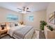Comfortable bedroom with neutral walls, ceiling fan and a large window at 1417 Pine Lake Rd, Orlando, FL 32808