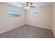 A well-lit bedroom with neutral walls, carpet, and a large window at 1417 Pine Lake Rd, Orlando, FL 32808
