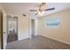 Cozy bedroom featuring neutral walls, carpet, a ceiling fan and an ample closet at 1417 Pine Lake Rd, Orlando, FL 32808
