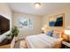 Bedroom with window, plant, night stands, and decorative painting at 1417 Pine Lake Rd, Orlando, FL 32808