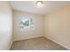Neutral bedroom with large window, neutral carpet, and base trim at 1417 Pine Lake Rd, Orlando, FL 32808