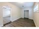 A view of the bright bedroom with vinyl floors, closet, and open doorway at 1417 Pine Lake Rd, Orlando, FL 32808