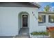 Up-close front entrance view featuring an arched entryway with a black front door at 1417 Pine Lake Rd, Orlando, FL 32808