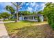 A single-story home with light blue paint, dark shutters, and a well-maintained lawn at 1417 Pine Lake Rd, Orlando, FL 32808