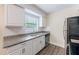 Kitchen with stone counters, subway tile backsplash and stainless steel appliances at 1417 Pine Lake Rd, Orlando, FL 32808