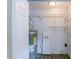 A well-lit laundry room with washer/dryer hookups, shelving and a water heater at 1417 Pine Lake Rd, Orlando, FL 32808