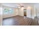 Bright living area features hard wood flooring, ceiling fan, bright paint, and natural light at 1417 Pine Lake Rd, Orlando, FL 32808