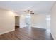 An open living area with hard wood flooring, ceiling fan, bright paint, and natural light at 1417 Pine Lake Rd, Orlando, FL 32808