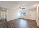 Living room featuring hardwood flooring, a ceiling fan, white wall paneling, and natural light at 1417 Pine Lake Rd, Orlando, FL 32808