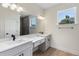 Modern bathroom with dual sinks, white quartz countertops, black hardware, and a separate shower room at 14470 Sw 46Th Ct, Ocala, FL 34473