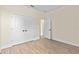 Bedroom featuring wood floors, white trim, closet, and an open doorway to the next room at 14470 Sw 46Th Ct, Ocala, FL 34473