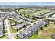 Expansive aerial view of the community featuring manicured landscapes, a golf course, and multiple residences at 1521 Flange Dr, Davenport, FL 33896