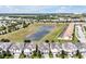 An aerial view showcases a neighborhood, a scenic pond, and green spaces in the background at 1521 Flange Dr, Davenport, FL 33896
