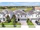 Stunning aerial view of a property showcasing its lush landscaping, nearby lake, and tile roof at 1521 Flange Dr, Davenport, FL 33896