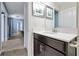 Stylish bathroom with modern fixtures and a hallway view to the living room and bedrooms at 1521 Flange Dr, Davenport, FL 33896
