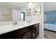 Bathroom with double vanity, white countertops and a mirror at 1521 Flange Dr, Davenport, FL 33896