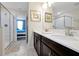 Bathroom with double vanity, white countertops and tiled glass shower at 1521 Flange Dr, Davenport, FL 33896