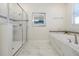 Bathroom featuring a glass-enclosed shower, soaking tub, and elegant marble tile accents at 1521 Flange Dr, Davenport, FL 33896
