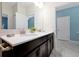Bathroom featuring double sinks, dark cabinets, and marble tile flooring, offering a stylish design at 1521 Flange Dr, Davenport, FL 33896