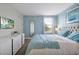 Bedroom featuring a queen bed, white dresser, and relaxing blue walls at 1521 Flange Dr, Davenport, FL 33896
