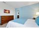 Bedroom featuring blue walls, carpet floors and television at 1521 Flange Dr, Davenport, FL 33896
