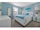 Serene bedroom with soothing blue walls, a full-length mirror, and bright natural light at 1521 Flange Dr, Davenport, FL 33896