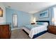 Blue bedroom with carpet floors, blue bedding and tasteful artwork at 1521 Flange Dr, Davenport, FL 33896