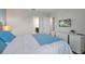 Bedroom with television, white dresser, carpet floors and blue accents at 1521 Flange Dr, Davenport, FL 33896