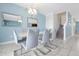 Stylish dining room with modern chandelier, mirrors, table with seating, and marble-style floors at 1521 Flange Dr, Davenport, FL 33896