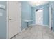 Bright foyer with marble floors, a white console table, and light blue walls at 1521 Flange Dr, Davenport, FL 33896