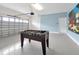 Spacious garage with foosball table, convenient garage door opener, and stylish epoxy floors at 1521 Flange Dr, Davenport, FL 33896