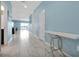 Hallway featuring white marble floors, a white console table and light blue walls at 1521 Flange Dr, Davenport, FL 33896
