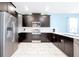 Modern kitchen featuring stainless steel appliances, dark cabinets, and bright white countertops and backsplash at 1521 Flange Dr, Davenport, FL 33896
