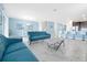 Open-concept living and dining area featuring marble floors, stylish sofas, and kitchen bar at 1521 Flange Dr, Davenport, FL 33896