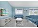 Bright, open-concept living room with light blue walls, marble floors, and stylish furnishings at 1521 Flange Dr, Davenport, FL 33896