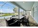 Screened patio with outdoor dining furniture overlooking the pool and backyard at 1521 Flange Dr, Davenport, FL 33896