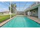 Large screened-in pool featuring clear water, an expansive patio, and a view of the manicured lawn at 1521 Flange Dr, Davenport, FL 33896