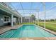 Screened-in pool overlooking a well-manicured lawn and golf course, perfect for relaxation and recreation at 1521 Flange Dr, Davenport, FL 33896