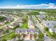 Community aerial view featuring beautiful ponds with fountain, manicured lawns, mature trees, and well-kept homes at 15822 Woodland Spring Ct, Orlando, FL 32828