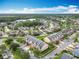 Community aerial view featuring manicured lawns, Gathering homes, mature trees, and tranquil ponds in an idyllic setting at 15822 Woodland Spring Ct, Orlando, FL 32828