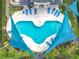 Aerial view of the community pool with ample lounge chairs and shaded areas to provide hours of enjoyment at 15822 Woodland Spring Ct, Orlando, FL 32828