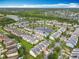 Community aerial view featuring beautiful homes, ponds with fountain, neighborhood landscaping, and manicured lawns at 15822 Woodland Spring Ct, Orlando, FL 32828