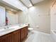 Modern bathroom featuring a double sink vanity, a large mirror, and neutral shower curtain at 15822 Woodland Spring Ct, Orlando, FL 32828