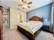 Bedroom showcasing a wooden bed frame and adjacent bathroom entrance, providing convenience and privacy at 15822 Woodland Spring Ct, Orlando, FL 32828