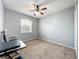 Neutral bedroom with a window and carpet, perfect for creating a serene retreat at 15822 Woodland Spring Ct, Orlando, FL 32828