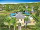 Gorgeous aerial view of a community pool and nearby serene pond with fountains at 15822 Woodland Spring Ct, Orlando, FL 32828
