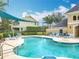 Inviting community pool with clear turquoise water, surrounded by lounge chairs and shaded by a blue awning at 15822 Woodland Spring Ct, Orlando, FL 32828